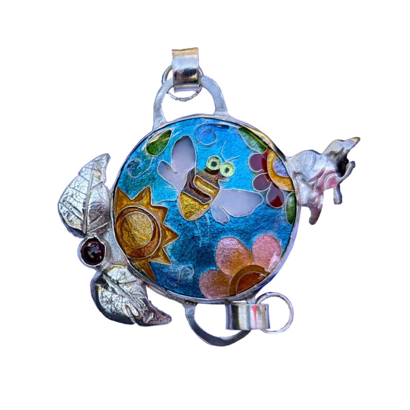 Jewelry artist Susan Shallenberger donated this enameled link with a centerpiece featuring a bee flowers and the sun. The link will be attached to the Links Project in it's 3rd case; which is new as of 202308.