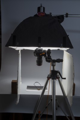 Light source above object on table top; white foam core on each side of object and camera aimed down at object.