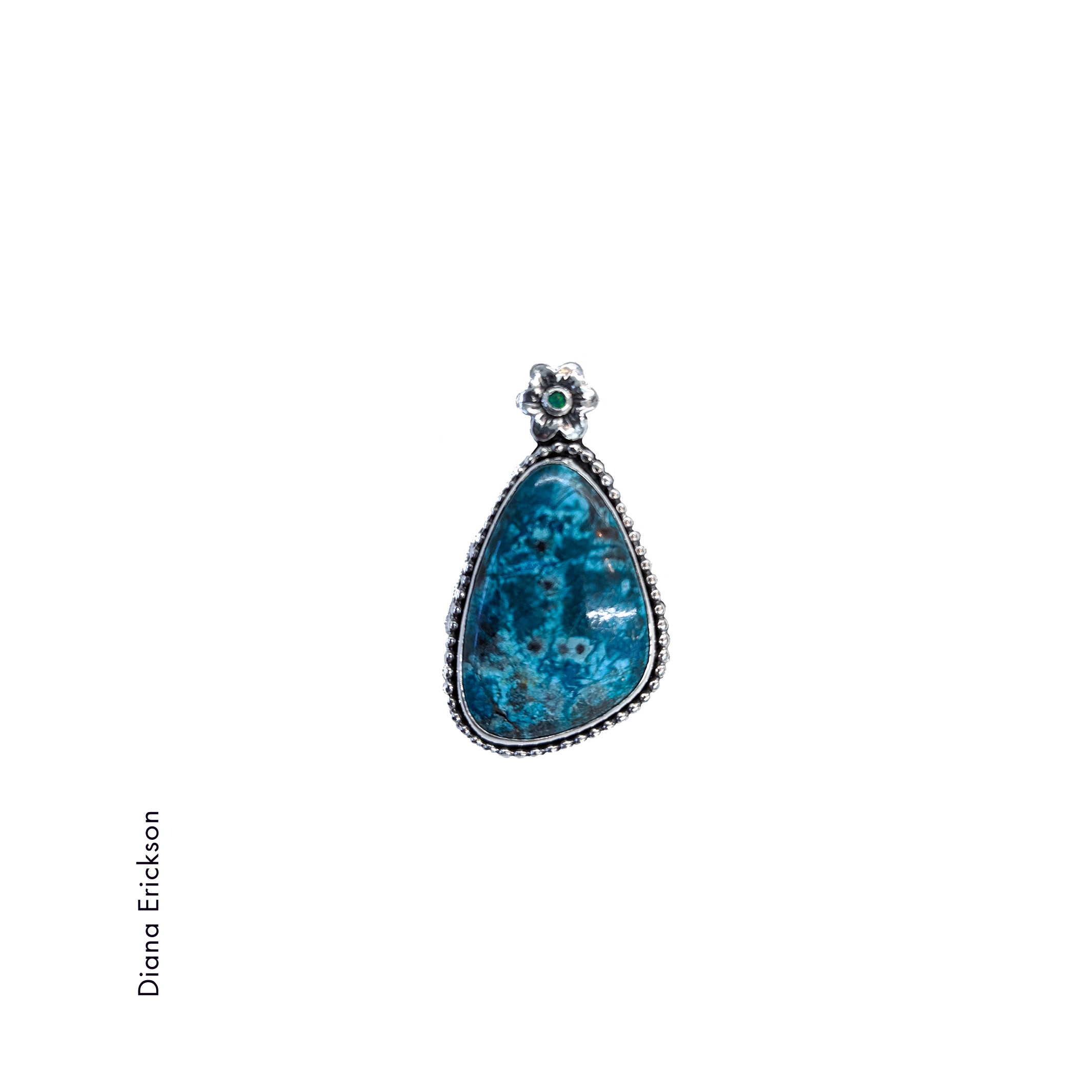 triangular deep blue turquoise stone with beaded sterling silver bezel and a silver flower / bail by Diana Erickson